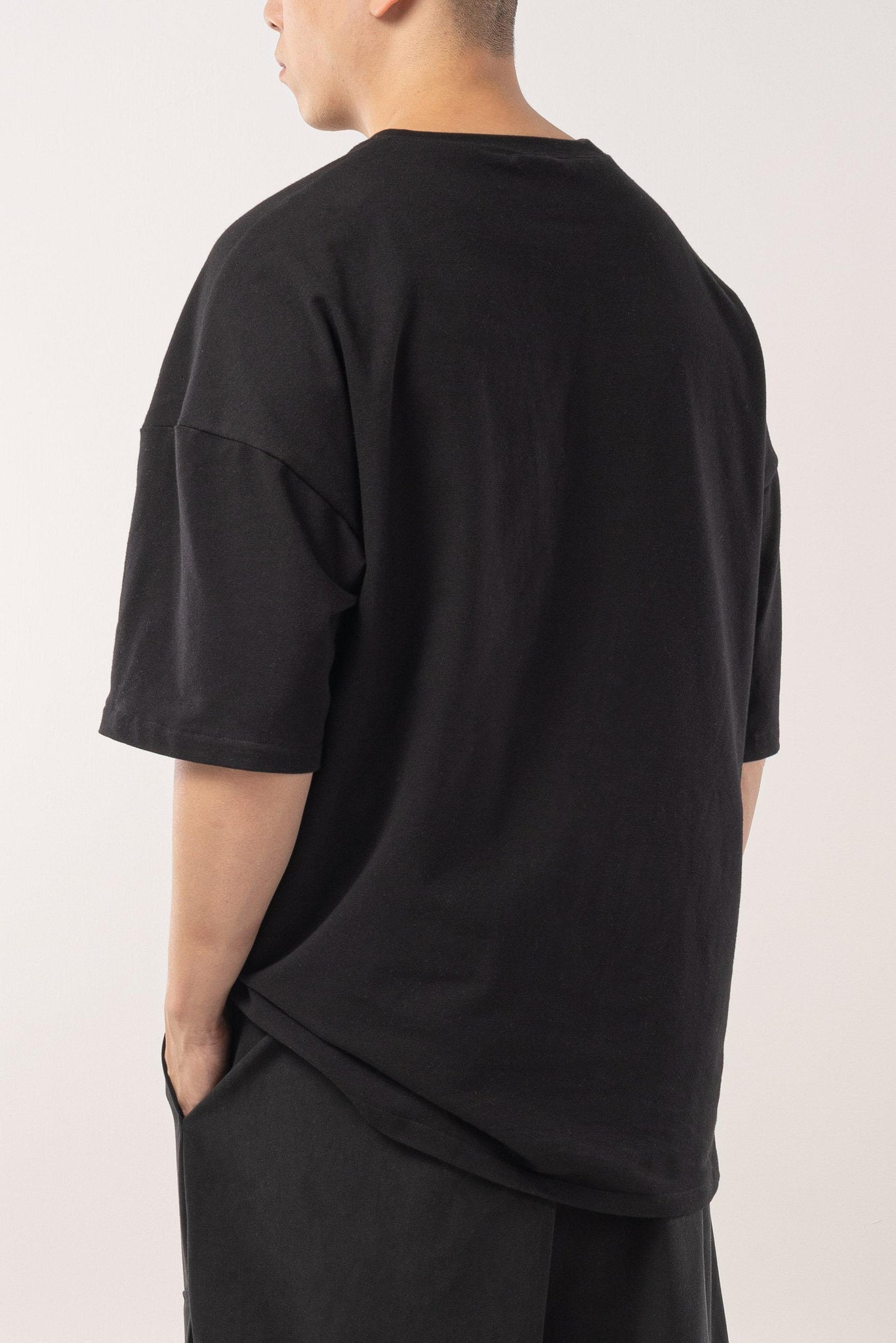 Loose fit black french terry T-shirt with drop shoulders.