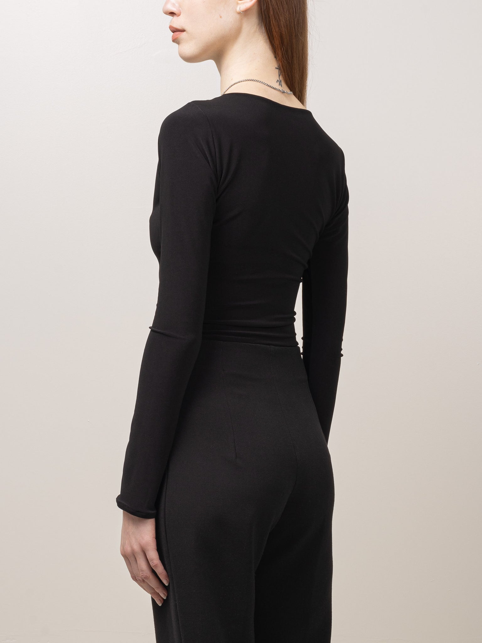 Fitted long sleeve top with cut out details at the front.