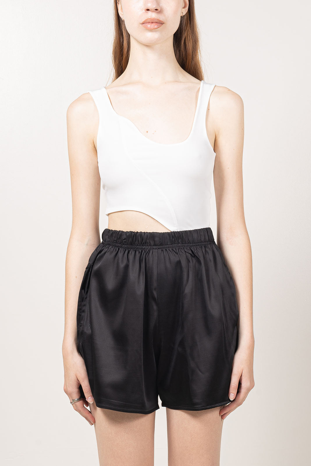 Fitted white tank top made with soft and stretchy knit.