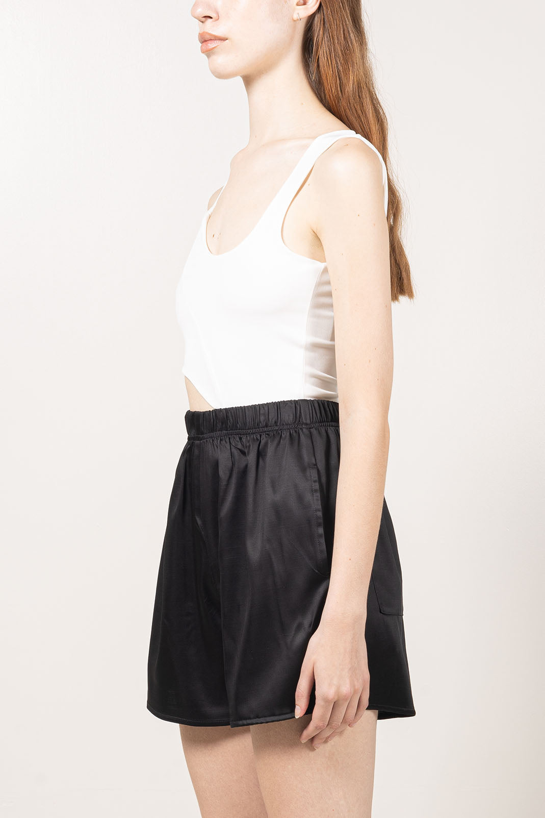 Fitted white tank top made with soft and stretchy knit.